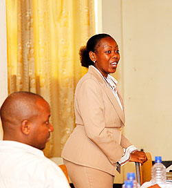 KCB Head of Mortgage, Beatrice Cheve adresses participants at the training of real estate agents, as the REAR president, Charles Haba, looks on yesterday. The New Times / Timothy Kisambira.