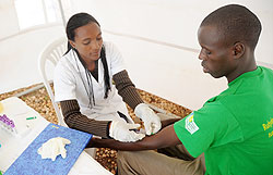 A young man voluntarily tests for HIV during the World AIDS day, Thursday.  The New Times / J. Mbanda.