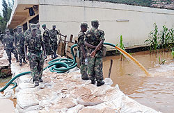 RDF soldiers take part in an exercise to drain flood waters  in Nyabugogo  yesterday. The New Times, John Mbanda.
