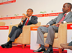 Finance Minister John Rwangombwa (L) speaks during the EA Summit yesterday. Looking on is EAC Secretary General, Richard Sezibera. The New Times / T.Kisambira.