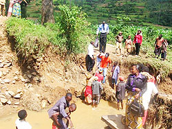  People struggle to cross the river after the  bridge broke down The New Times /Sam Nkurunziza