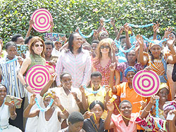 Deborah Lloyd (centre) of Kate Spade, Joy Ndugutse (centre) of Gahaya Links and Karen Sherman (left in glasses) pause with women employees of Gahaya Links.Tne New Times/ Courtesy 
