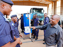  Dr. Alexis Nzahabwanimana, the Minister of State for Transport, (R) chats with Emmanuel Butera (L), Commissioner for operations as Supt Bernard Nsengiyumva looks on. The minister was on a tour of the Gasabo-based auto-mobile inspection centre. The New Ti