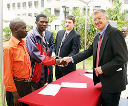 US Ambassador to Rwanda, Donald Koran shakes hands with some of the beneficiaries of the US$50,000 grant after the signing ceremony yesterday. The New Times / Courtesy.