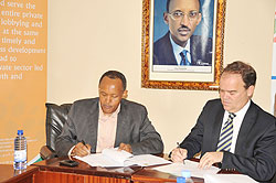 PSF Chairman Faustin Mbundu (L) and Mark Priestley of Trade Mark East Africa during the signing of a US$1.4 million grant yesterday. The New Times / Grace Mugoya.