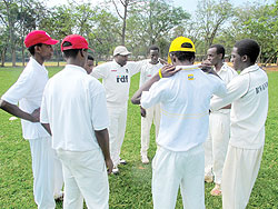 Impala Titans players converge for a brief team talk before this year's Sulfo cricket league final against Right Guards at Kicukiro oval. The New Times/O. Arinaitwe.