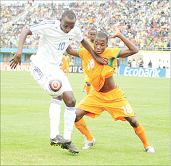 Andrew Buteera (L) shields the ball from an Ivory Coast player in the Caf U-17 Championship early this year. The Amavubi midfielder is expected to go under the knife this month. The New Times / File.