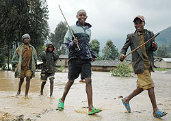 oung boys play in a flooded area in Rubavu District. Local authorities have been told to map out disaster-prone areas. The New Times File