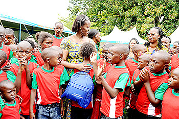 First Lady giving Christmas gifts to children who attended the Party.