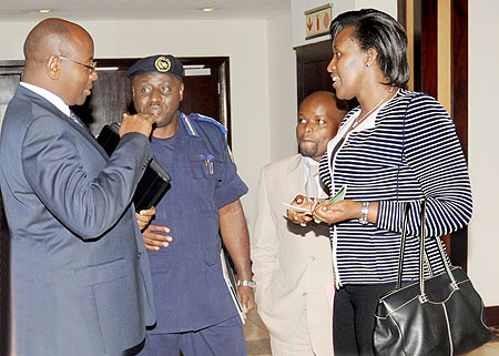 First Lady Mrs. Kagame (R), talks to IGP Gasana, Local Gov't Minister James Musoni (L) and Youth Minister, Jean Philbert Nsengimana, during the meeting on alcohol and drug abuse among the youth, yesterday. The New Times / J.Mbanda.
