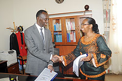 Former Chief Justice Aloysia Cyanzayire (R) hands over to her successor Sam Rugege yesterday. The New Times / J. Mbanda.
