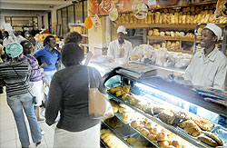 shoppers at Simba supermarket decided to offer a discount of 5 percent to attract more clients.The New Times / J. Mbanda.
