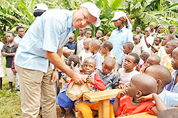 Rodolphe Kembukunswa of Rotary Club Kigali Doyen distributing gifts to the children. The New Times /Courtesy.