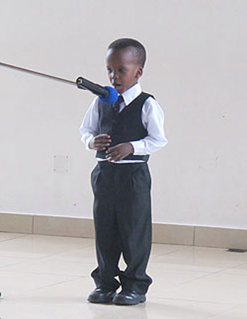 A little boy recites a poem to listeners.