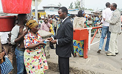 An immigration officer checks people's documents at the Rwanda- DR Congo border. Rubavu residents are only required to use IDs to cross into DRC. The New Times / John Mbanda.