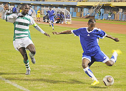Kiyovuu2019s captain Eric Serugabe (left) tries to  block Rayonu2019s Djamal Mwisenezau2019s cross during last season league clash. (The New Times; File)