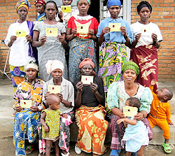 Women flash their health insurance cards. 
