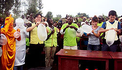 GN Rwanda and KOICA volunteers join residents to demonstrate the safety of condoms during the campaign.