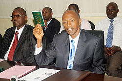 The Director General of Immigration and Emigration, Anaclet Kalibata, unveils the new travel document, Laissez-Passer, at his office in Kacyiru yesterday. The New Times /John Mbanda.