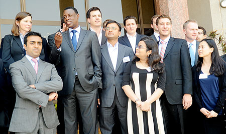 Defence Minister Gen. James Kabarebe, chats with students from Wharton University at his offices yesterday. The New Times / John Mbanda.