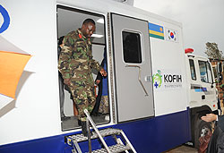 Kanombe Hospital Director, Col Ben Karenzi alights from one of  the mobile clinic vans. The facilities offer the same services rendered by referral hospitals. 