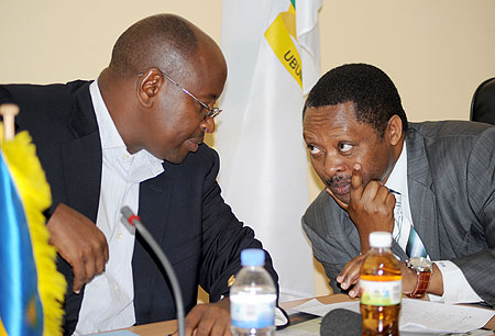 Local Government Minister James Musoni (L), and the CEO of Rwanda Governance Board, Prof. Anastase Shyaka, consult at a news conference yesterday. The New Times / John Mbanda.