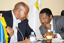 Local Government Minister James Musoni (L), and the CEO of Rwanda Governance Board, Prof. Anastase Shyaka, consult at a news conference. The New Times/John Mbanda.