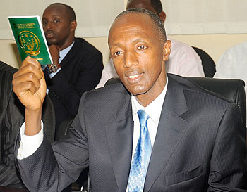 The Director General of Immigration and Emigration, Anaclet Kalibata, unveiled the new pocket-size travel document. The New Times / John Mbanda.