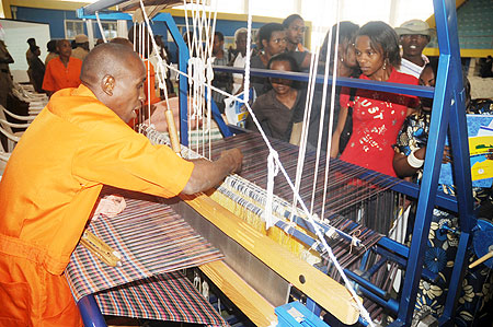 A prisoner makes a fabric during an  Open Day organised by   Ministry of Internal Security, at  Petit Stadium, Remera, yesterday. The New Times / J. Mbanda.