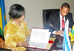 World Bank Country Manager, Mimi Ladipo, and Finance Minister, John Rwangombwa, sign the financing agreement yesterday. The New Times / John Mbanda.