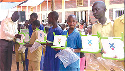 Mayange Primary School pupils receiving laptops. Education officials say indiscipline among students affects their performance. The New Times / File.