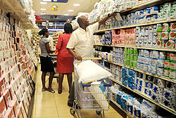 Shoppers select items from a Kigali store. Most of the goods are imported from the region.  The New Times / File.