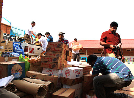 Members of the Malayalee association offload donations to assist orphans at Mother Theresa Orphanage. The New Times G.Mugoya