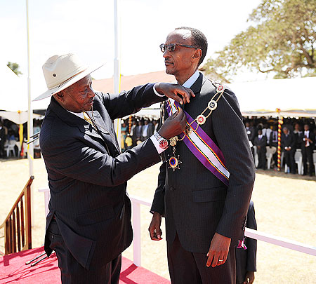 President Kagame being decorated by Ugandan President Yoweri Museveni during the NRMu2019s 26th Anniversary celebrations in Kapchorwa yesterday. The New Times/Village Urugwiro.