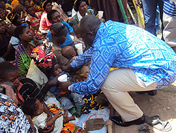 PM Habumuremyi offers milk  to  a child, kick starting the  national campaign against malnutrition. The New Times  JP Bucyensenge