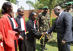 Prime Minister Pierre Damien Habumuremyi (L) congratulates the sworn in prosecutors yesterday The New Times / J. Mbanda