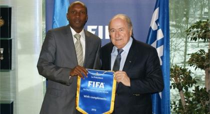 Abega poses for a photo with Fifa president Blatter