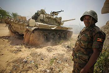 A Ugandan soldier serving with the African Union Mission in Somalia stands guard as a tank passes following an advance with the Somali National Army to capture Mogadishu University, on January 20. Net  Photo.