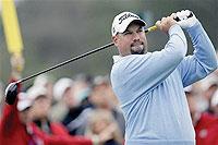 Brendon de Jonge of Zimbabwe watches his tee shot. Net photo.