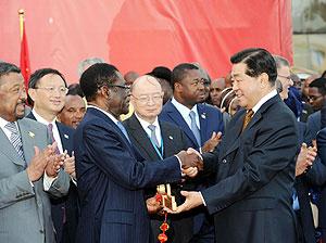 Jia Qinglin (R, front), chairman of the National Committee of the Chinese Peopleu2019s Political Consultative Conference, hands over the golden key which represents the new Conference Center for the African Union (AU) to Equatorial Guinean President and AU Ch