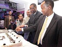 The Minister of Sports and Culture Protais Mitali (2nd right) cuts the cake with the proprietor of K-Club and Brima Business Centre, Emile Mulego with his wife (L), and Dieudonnu00e9 Sebashongore, Chairman, Kigali City Council (R), to officially launch the cl