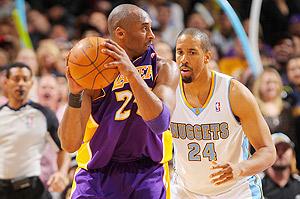Kobe Bryant of the Los Angeles Lakers controls the ball against Andre Miller of the Denver Nuggets. 
