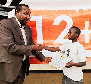 Philbert Rugumire (L) PSI's Marketing and training Director giving a certificate to Aisha Uwaremwe. The SundayTimes /  t. Kisambira