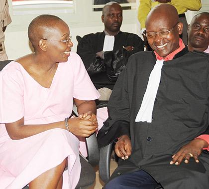 Victoire Ingabire sharing a light moment with her lawyer Gatera Gashabana as she appeared before court. The New Times / file