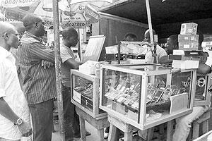 People queue at a handset dealer in Lagos in 2008.  Net photo.