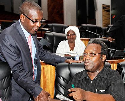 Juvenal Nkusi, president of PAC (R) chatting with Evariste Kalisa, Deputy speaker of parliament, before the beginning of the session. The New Times / T. Kisambira.