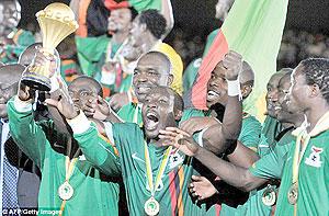 Zambia players show off the 2012 Africa Nations Cup trophy shortly after beating Ivory Coast on penalties. The players are set to earn huge bonuses. Net photo.