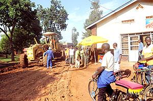 Masaka residents watch in amazement as their road is being constructed yesterday. The Sunday Times / John Mbanda.