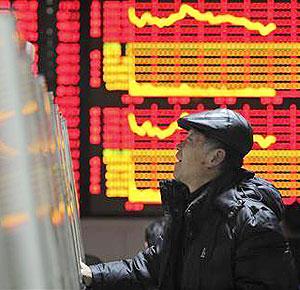 An investor checks stock information with a computer at a brokerage house in Hefei, Anhui province February 20, 2012. China shares ended up 0.3 percent on Monday .