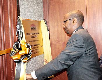 Finance Minister John Rwangombwa unveils a plaque at the official opening of Equity Bank recently. The New Times / T. Kisamba. 